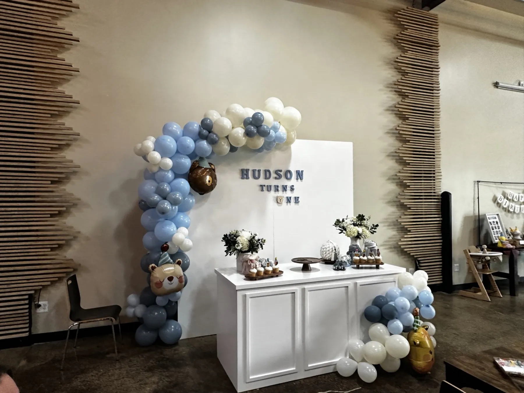 A balloon arch and dessert table set up in the mezzanine for a private party